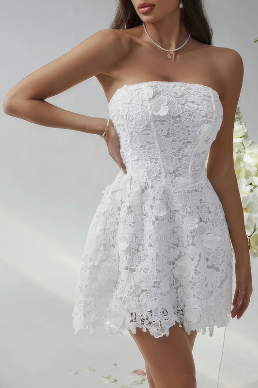 White lace strapless dress worn by a model on a light background