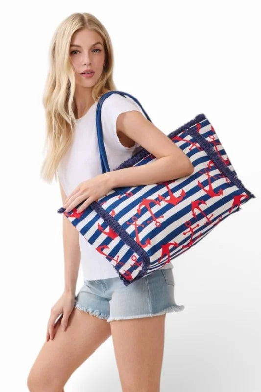 Woman holding a large tote bag with nautical design on a white background
