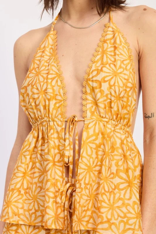 Yellow floral patterned dress on a plain background