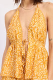 Yellow floral patterned dress on a plain background