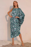 Woman wearing a green leaf-patterned dress against a white background