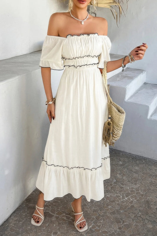 Woman wearing a white off-shoulder dress with a textured background