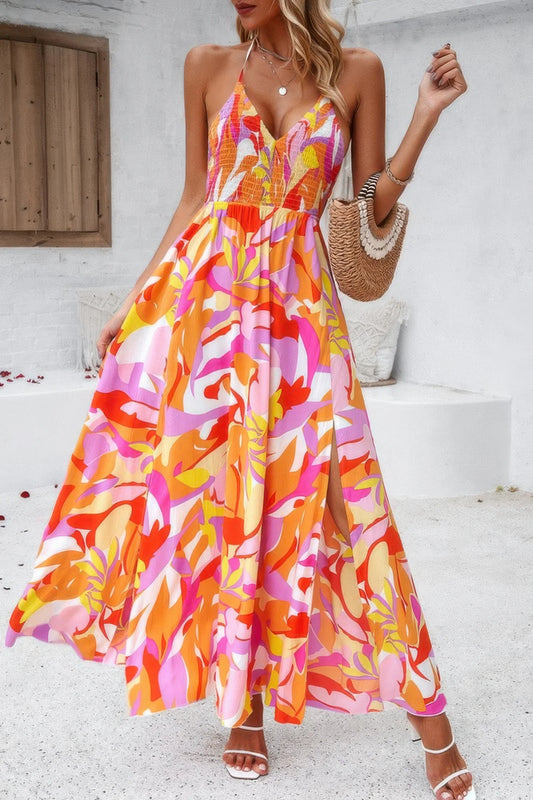 Woman wearing a colorful floral dress on a white steps background