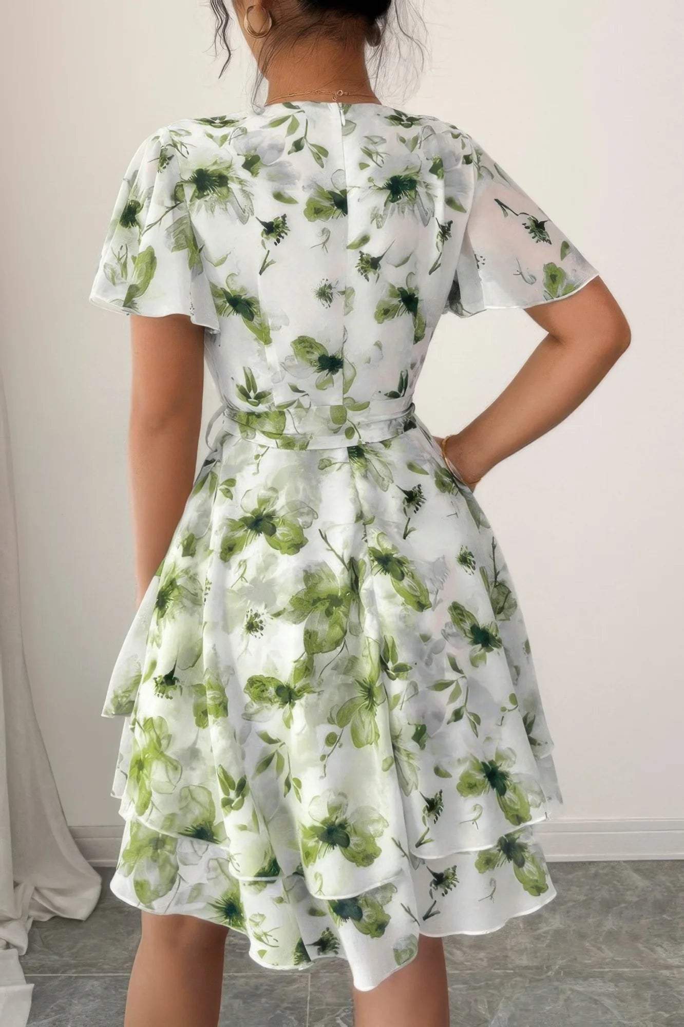 Woman wearing a floral dress with a plain background