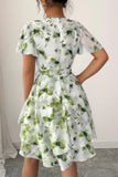 Woman wearing a floral dress with a plain background