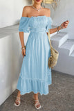 Woman wearing a light blue off-shoulder dress with a white background