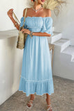 Woman wearing a light blue off-shoulder dress with a white background