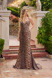 A woman wears the Juliet JT2734H, a leopard print dress featuring a lace-up back, standing in an outdoor setting with classical architecture and greenery.