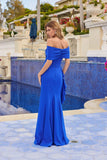 A woman in the Juliet JT2716C long prom dress stands by a pool, facing away from the camera in an elegant outdoor setting.