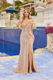 A woman in the champagne-colored Juliet JT2723C long prom dress, featuring a form-fitting silhouette, sparkling details, one-shoulder neckline, and high slit, stands by a blue-tiled pool amid ornate decor and flowers.