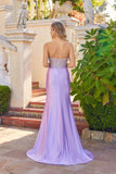 A woman wears the Long Prom Dress: Juliet JT2729H, featuring a strapless corset, beaded fitted bodice, and floor-length lavender skirt, as she stands outdoors on a tiled patio facing away from the camera.