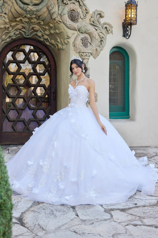 Woman in a white wedding dress standing in front of an ornate building entrance.