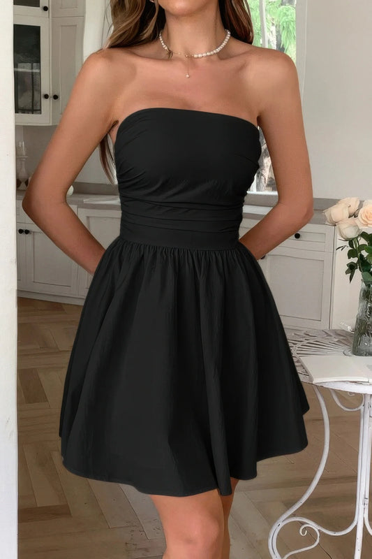 Woman wearing a black strapless dress in a kitchen setting