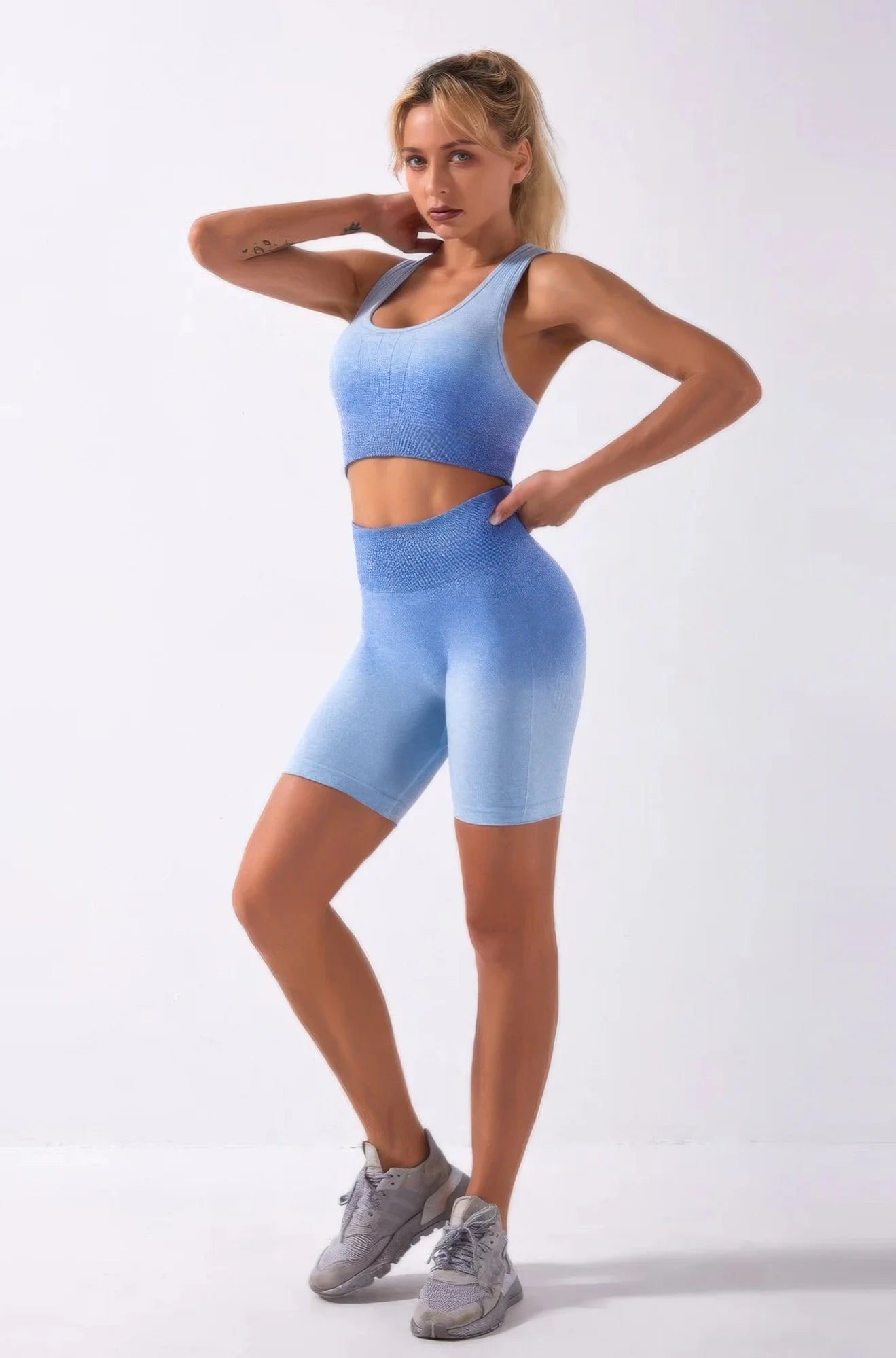 Woman wearing a blue athletic outfit on a white background