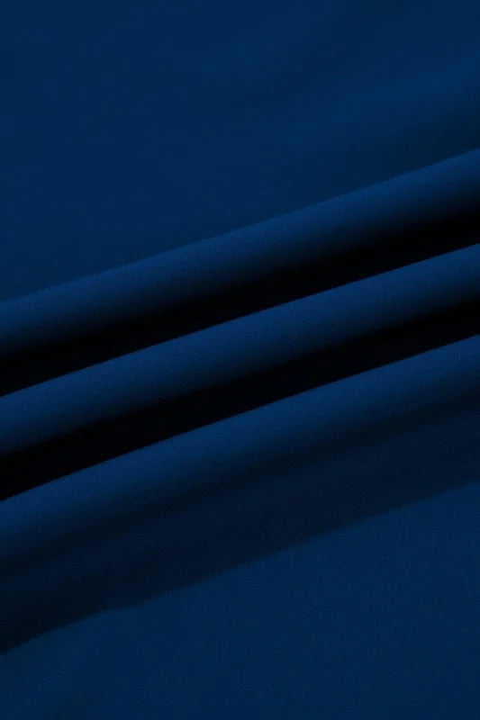 Close-up of blue fabric with folds on a dark background