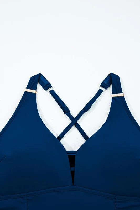 Blue bikini top with criss-cross straps on a white background