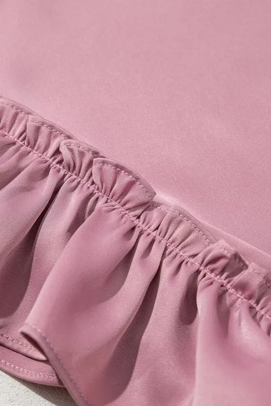 Close-up of pink fabric with ruffled edge on a pink background