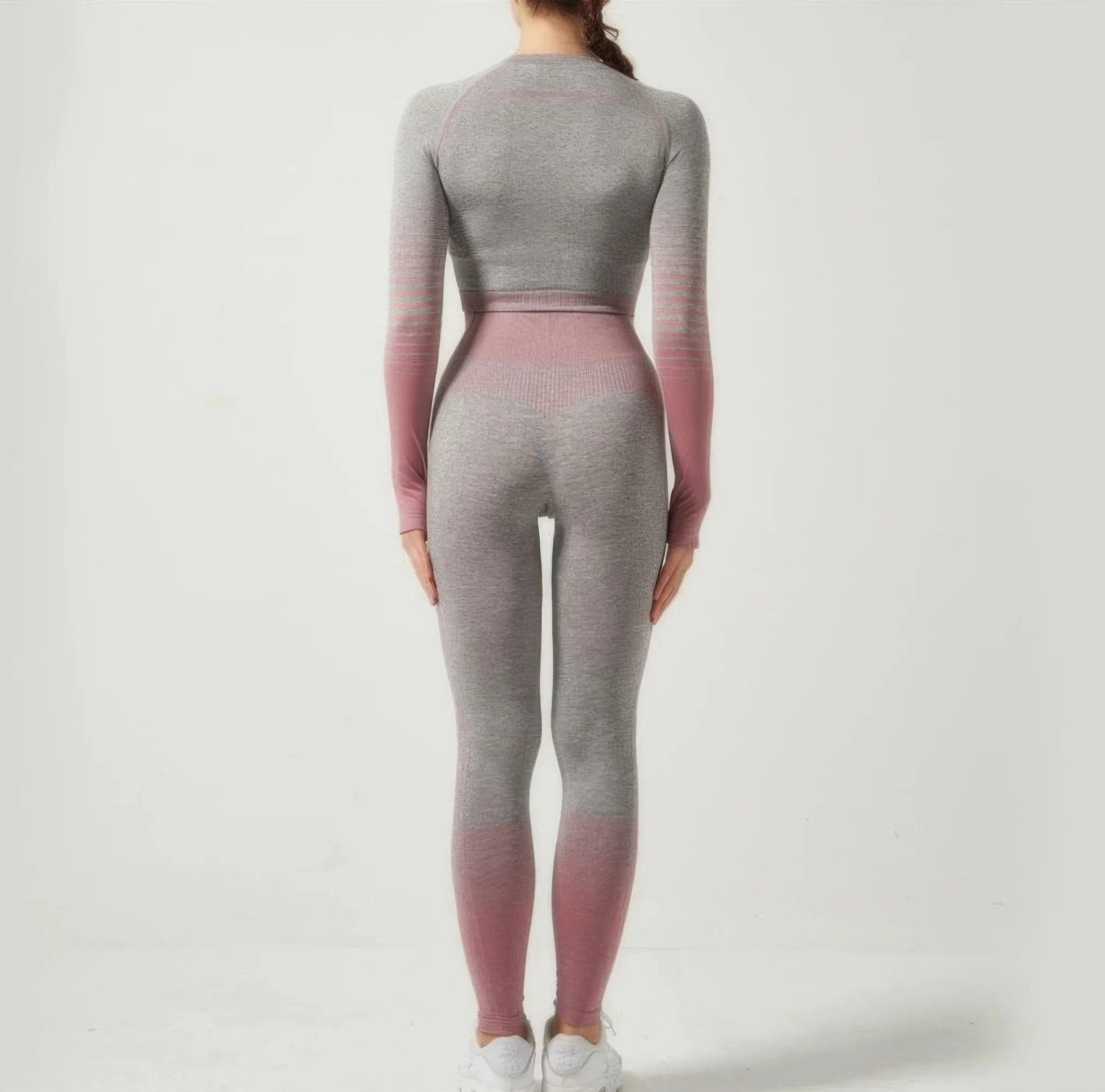 Person wearing a gray and pink gradient outfit on a white background