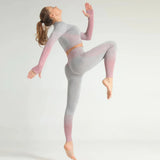 Person wearing a gray and pink outfit on a plain background