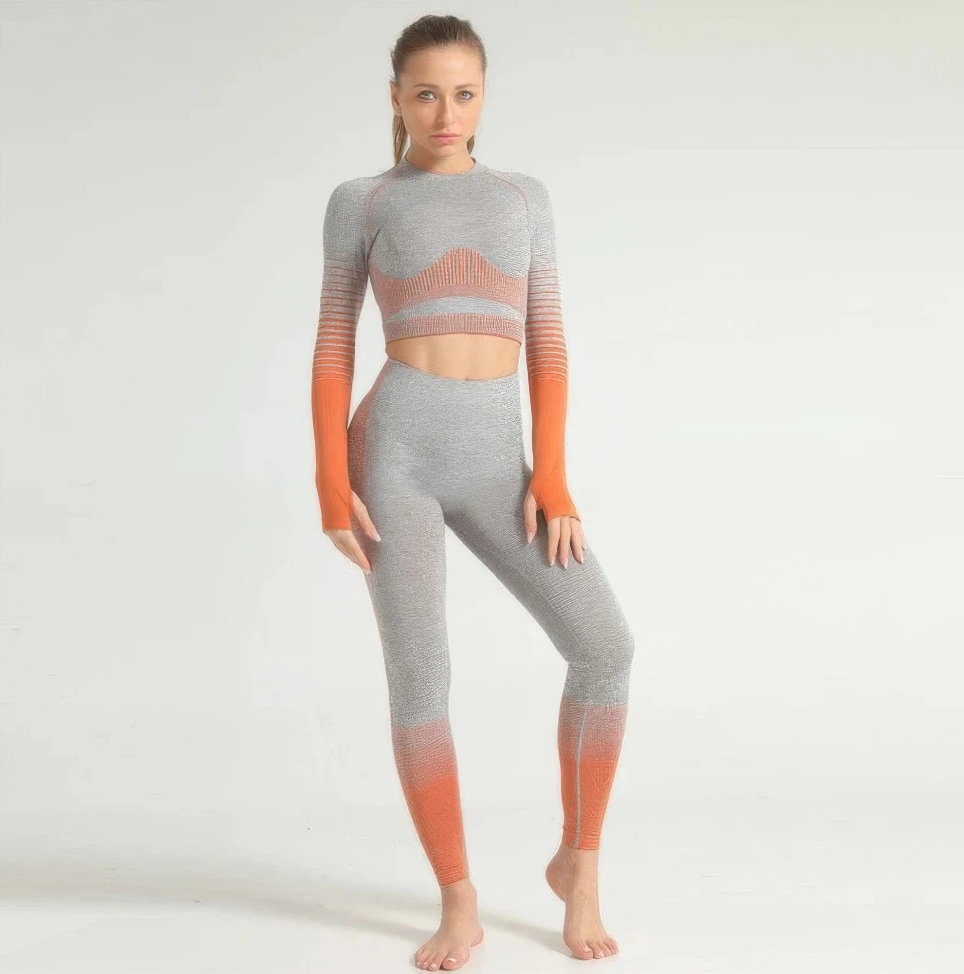 Woman wearing a gray and orange gradient athletic outfit on a white background