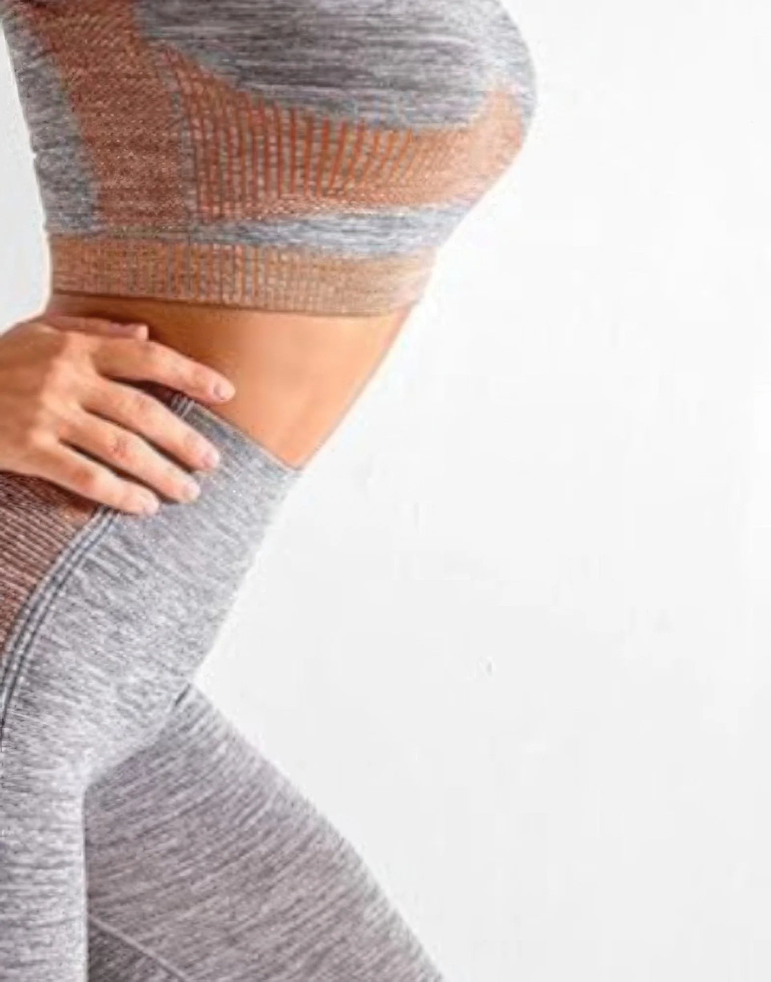 Gray and brown patterned leggings worn by a person on a white background